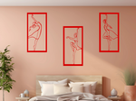 Metal wall art set featuring three minimalist ballerina silhouettes in various elegant dance poses, finished in Signal Red powder coating, mounted on a light peach wall above a bed, adding a graceful and artistic touch to the bedroom.