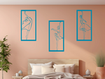 Metal wall art set featuring three minimalist ballerina silhouettes in various elegant dance poses, finished in Wedgwood Satin powder coating, mounted on a light peach wall above a bed, adding a graceful and artistic touch to the bedroom.