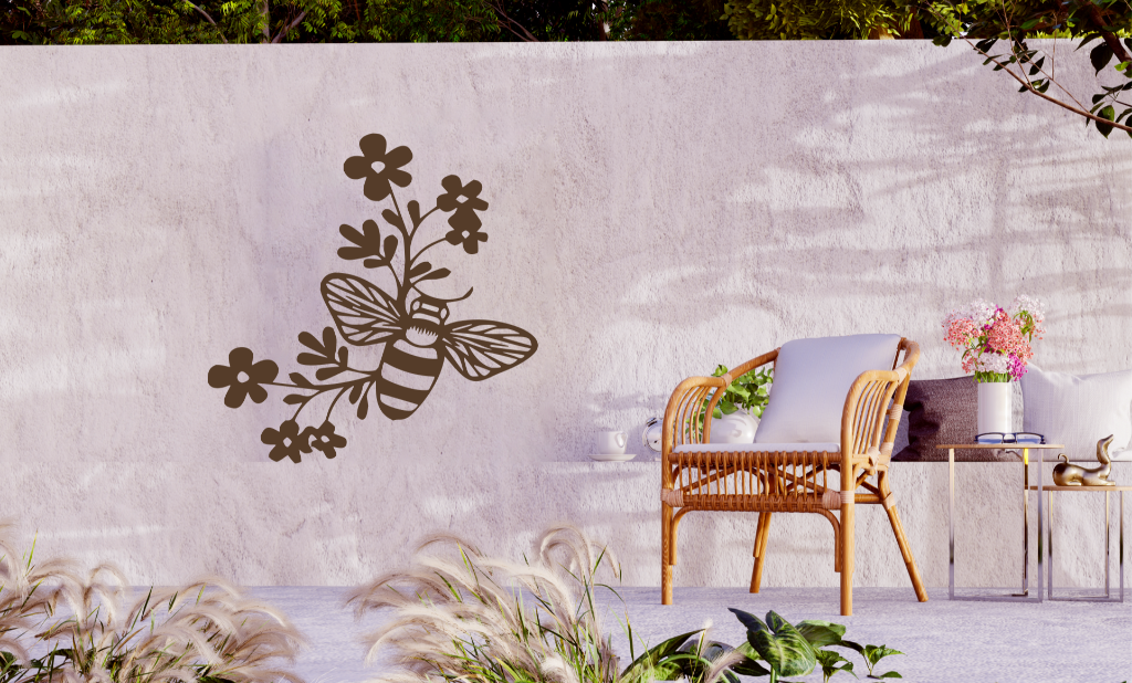 Metal wall art featuring a bee resting on a floral branch, finished in Rust Patina powder coating, mounted on an outdoor wall, adding a natural and playful touch to garden decor.