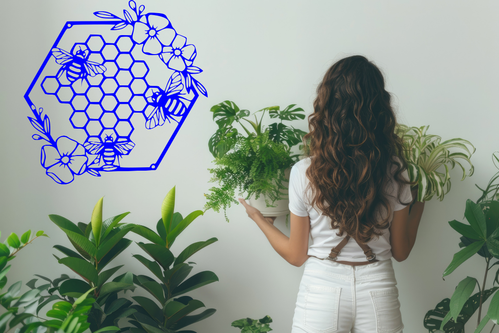 Metal wall art featuring three bees hovering over a floral honeycomb pattern, finished in Blaze Blue Gloss powder coating, mounted on a light-colored wall, complementing indoor plants and creating a nature-inspired decor