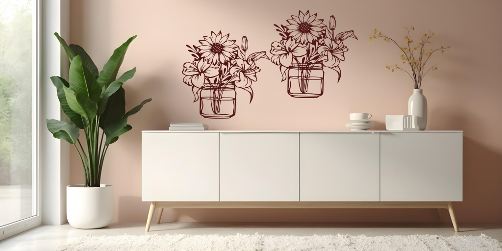 Metal wall art set featuring two jars filled with blooming flowers, including sunflowers and lilies, finished in Rust Patina powder coating, mounted on a soft pink wall above a modern white cabinet, creating a cheerful and nature-inspired interior decor.