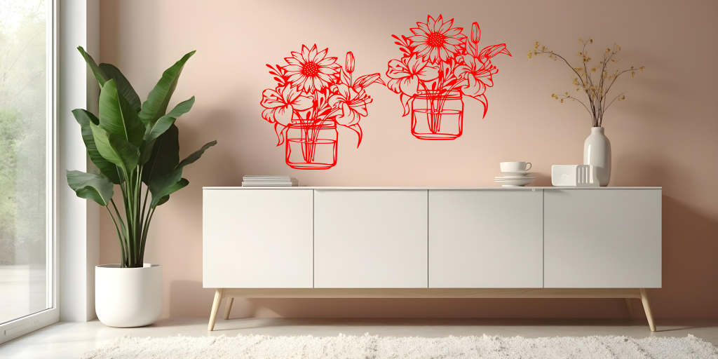 Metal wall art set featuring two jars filled with blooming flowers, including sunflowers and lilies, finished in Signal Red powder coating, mounted on a soft pink wall above a modern white cabinet, creating a cheerful and nature-inspired interior decor.