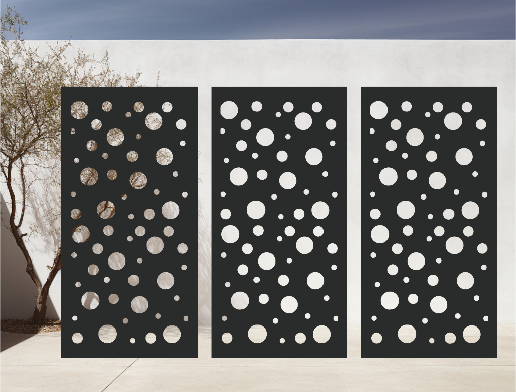 Metal privacy screen with a modern bubble pattern of varying circle sizes, finished in Night Sky Matt Black powder coating, displayed outdoors against a white wall, providing both privacy and an artistic element to the space.