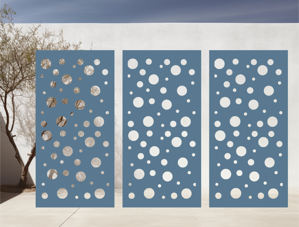 Metal privacy screen with a modern bubble pattern of varying circle sizes, finished in Wedgwood Satin powder coating, displayed outdoors against a white wall, providing both privacy and an artistic element to the space.