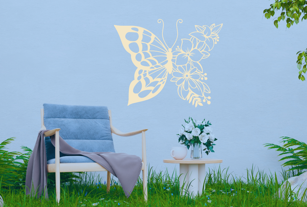 Metal wall art featuring a butterfly design with one wing made of floral patterns, finished in Canola Cream powder coating, mounted on an outdoor wall, adding a whimsical and nature-inspired touch to a cozy garden seating area.