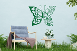 Metal wall art featuring a butterfly design with one wing made of floral patterns, finished in Mistletoe powder coating, mounted on an outdoor wall, adding a whimsical and nature-inspired touch to a cozy garden seating area.