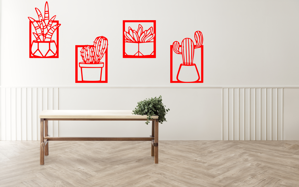 Metal wall art set featuring four distinct cactus designs in minimalist frames, finished in Signal Red powder coating, creating a modern, playful touch to a neutral-toned interior space with a light wooden bench and soft lighting.