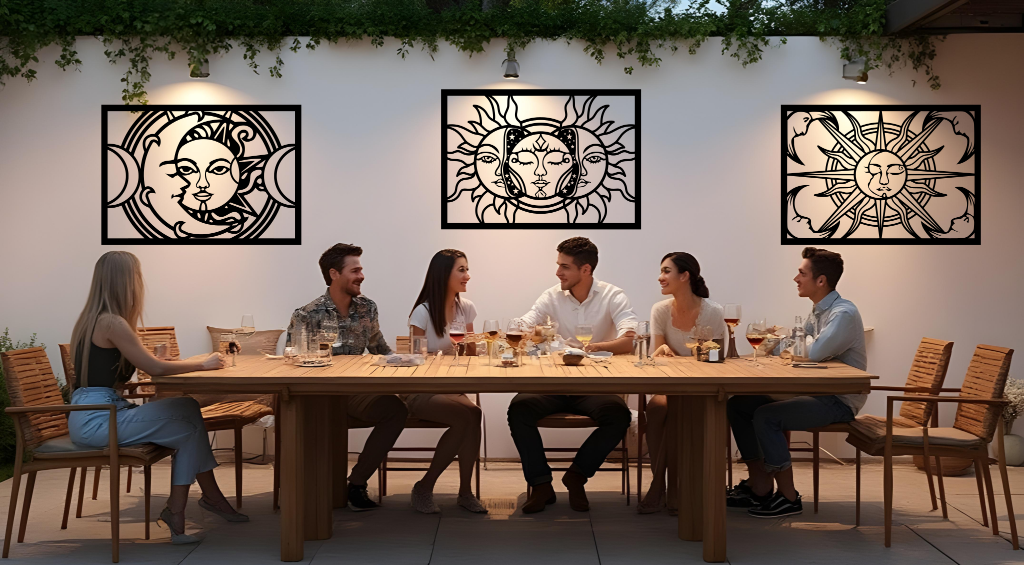 Metal wall art set featuring celestial designs with the sun and moon, finished in Night Sky Matt Black powder coating, mounted on an outdoor wall above a dining space, enhancing the ambiance of a social gathering with a mystical and artistic touch.