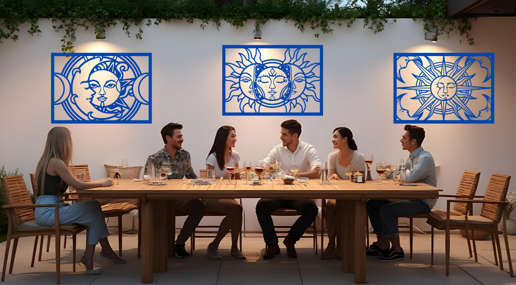 Metal wall art set featuring celestial designs with the sun and moon, finished in Blaze Blue Gloss powder coating, mounted on an outdoor wall above a dining space, enhancing the ambiance of a social gathering with a mystical and artistic touch.