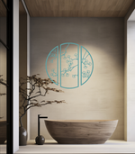 Metal wall art featuring a circular design divided into three panels with intricate cherry blossom branches, finished in Wedgwood Satin powder coating, mounted on a light wall in a modern, minimalist bathroom, adding a serene and nature-inspired touch to the space.