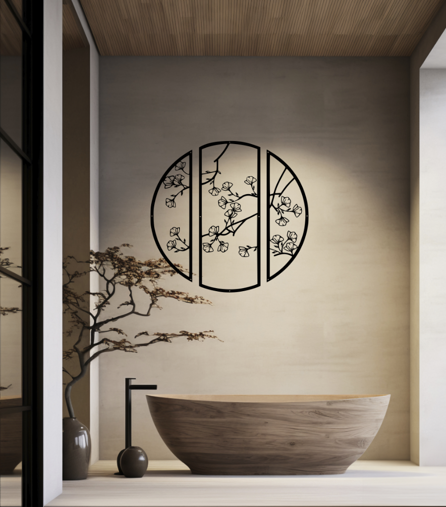 Metal wall art featuring a circular design divided into three panels with intricate cherry blossom branches, finished in Night Sky Matt Black powder coating, mounted on a light wall in a modern, minimalist bathroom, adding a serene and nature-inspired touch to the space.