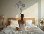 Metal wall art featuring a cross with a silhouette of Jesus wearing a crown of thorns, finished in Berry Grey Gloss powder coating, mounted on a light wall above a bed, adding a serene and spiritual element to the bedroom.