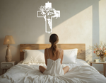 Metal wall art featuring a cross with a silhouette of Jesus wearing a crown of thorns, finished in Bright White Gloss powder coating, mounted on a light wall above a bed, adding a serene and spiritual element to the bedroom.