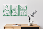 Metal wall art set featuring three minimalist line-drawing silhouettes of feminine figures in graceful poses, finished in Mistletoe powder coating, mounted on a white wall above a natural wood console, adding an elegant and artistic touch to modern interiors.