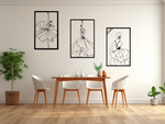 Metal wall art set featuring three minimalist line-drawing silhouettes of elegant flamenco dancers in flowing dresses, finished in Night Sky Matt Black powder coating, mounted on a white wall in a modern dining area with light wood furniture, adding a dynamic and artistic touch to the space.