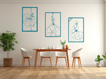 Metal wall art set featuring three minimalist line-drawing silhouettes of elegant flamenco dancers in flowing dresses, finished in Wedgwood Satin powder coating, mounted on a white wall in a modern dining area with light wood furniture, adding a dynamic and artistic touch to the space.