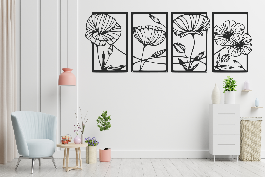 Set of four metal wall art pieces featuring intricate floral designs, finished in Night Sky Matt Black powder coating. The artwork is displayed on a white wall in a modern living room setting with soft pastel tones and cozy furniture, adding a natural and elegant touch to the space.