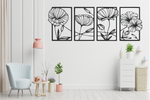 Set of four metal wall art pieces featuring intricate floral designs, finished in Night Sky Matt Black powder coating. The artwork is displayed on a white wall in a modern living room setting with soft pastel tones and cozy furniture, adding a natural and elegant touch to the space.