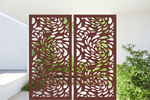 Metal privacy screen featuring a swirling droplet pattern, finished in Manor Red powder coating. The screen is displayed outdoors with green foliage visible through the cutout design, offering an elegant and organic element to any outdoor space.