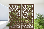 Metal privacy screen featuring a swirling droplet pattern, finished in Rust Patina powder coating. The screen is displayed outdoors with green foliage visible through the cutout design, offering an elegant and organic element to any outdoor space.