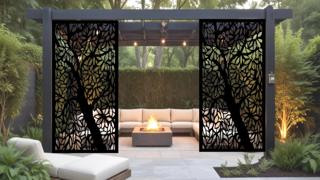 Metal privacy screen named 'Forest Intertwine,' featuring a silhouette of entwined branches and leaves, finished in Night Sky Matt Black powder coating. Displayed within an elegant outdoor seating area, creating a natural and serene ambiance