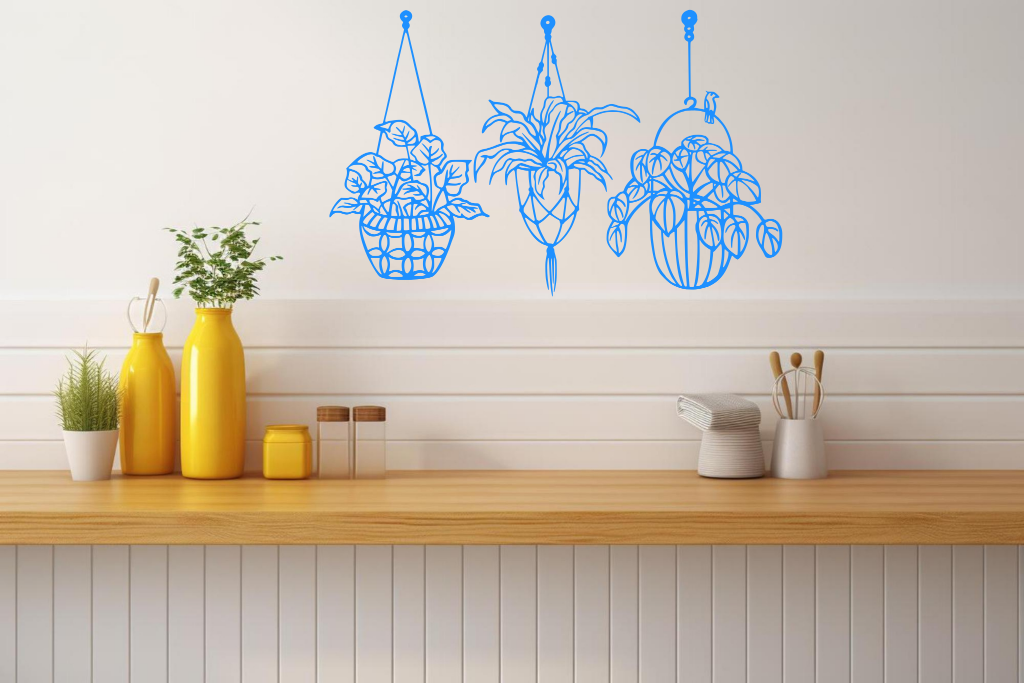 Metal wall art featuring three hanging planters with intricate plant designs, finished in Blaze Blue Gloss powder coating, mounted on a kitchen wall. The piece brings a natural and modern aesthetic to the space, complementing the vibrant yellow decor elements on the counter below.