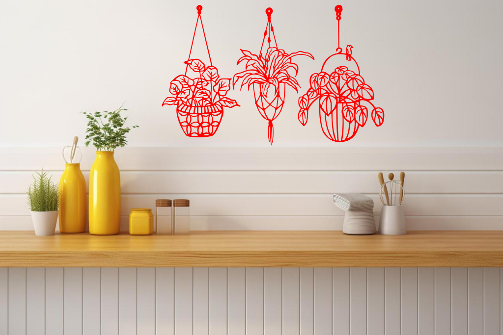 Metal wall art featuring three hanging planters with intricate plant designs, finished in Signal Red powder coating, mounted on a kitchen wall. The piece brings a natural and modern aesthetic to the space, complementing the vibrant yellow decor elements on the counter below.