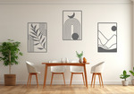 A three-piece minimalist geometric metal wall art set featuring abstract shapes, including a leaf design, a rainbow with moon and sun, and a mountain landscape, all finished in Berry Grey Gloss powder coating. The artwork is mounted on a dining room wall above a simple wooden table with white chairs, bringing a modern and artistic touch to the space.