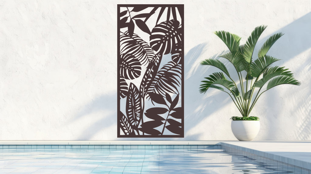 The 'Rainforest Leaves' metal privacy screen featuring an intricate design of tropical leaves, finished in Rust Patina powder coating. The screen is mounted on a white wall near a serene poolside area with a large potted plant, adding a rustic and stylish touch to the outdoor space