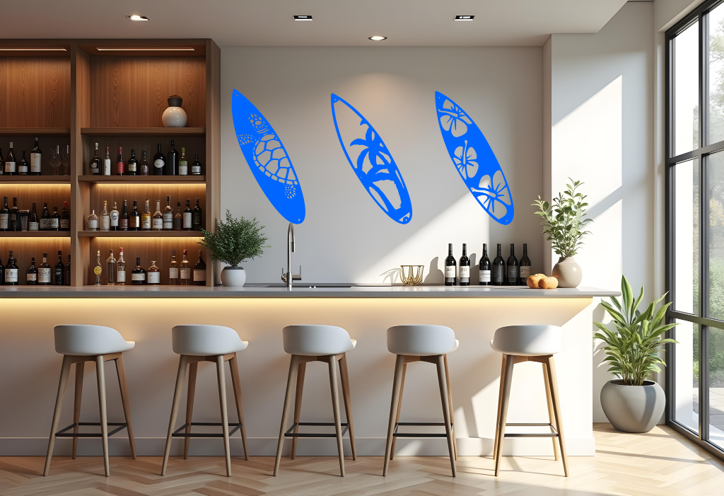 Metal wall art set featuring three surfboards with tropical and marine-themed cutouts, including a turtle, palm trees, and hibiscus flowers, finished in Blaze Blue Gloss powder coating, mounted on a light wall in a modern home bar, adding a coastal and relaxed atmosphere.