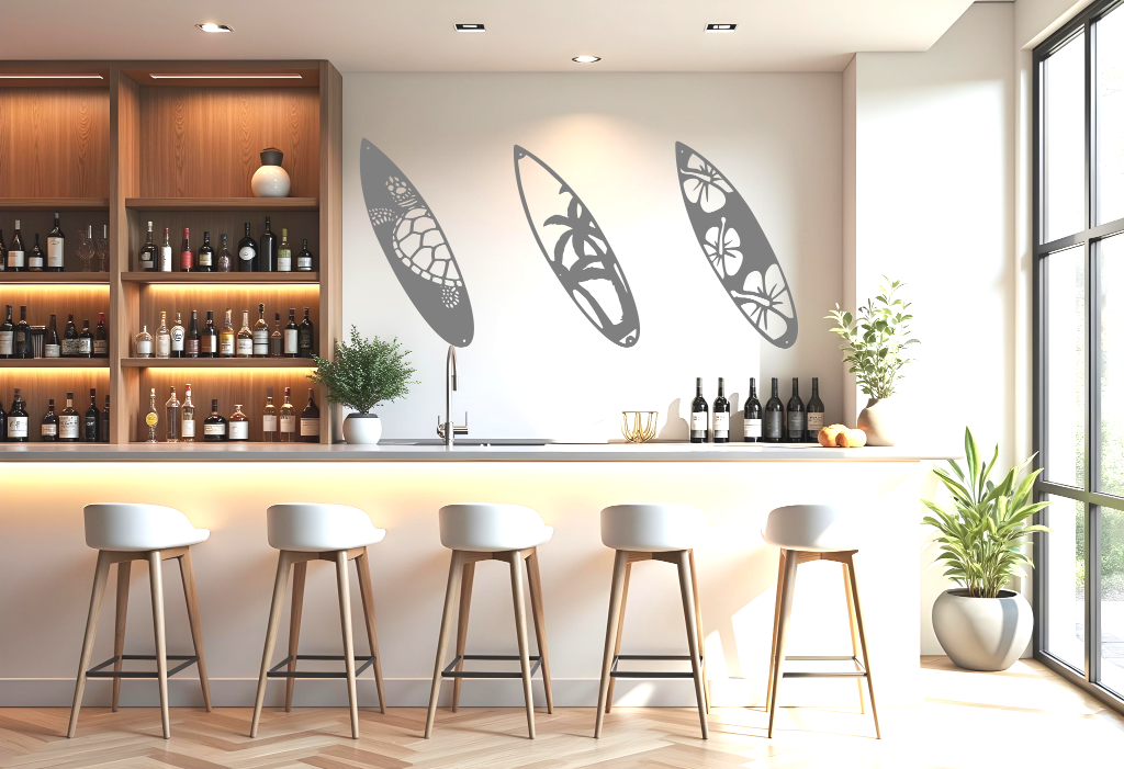 Metal wall art set featuring three surfboards with tropical and marine-themed cutouts, including a turtle, palm trees, and hibiscus flowers, finished in Berry Grey Gloss powder coating, mounted on a light wall in a modern home bar, adding a coastal and relaxed atmosphere.