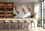 Metal wall art set featuring three surfboards with tropical and marine-themed cutouts, including a turtle, palm trees, and hibiscus flowers, finished in Rust Patina powder coating, mounted on a light wall in a modern home bar, adding a coastal and relaxed atmosphere.