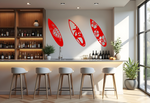 Metal wall art set featuring three surfboards with tropical and marine-themed cutouts, including a turtle, palm trees, and hibiscus flowers, finished in Signal Red powder coating, mounted on a light wall in a modern home bar, adding a coastal and relaxed atmosphere