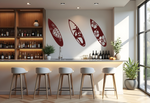 Metal wall art set featuring three surfboards with tropical and marine-themed cutouts, including a turtle, palm trees, and hibiscus flowers, finished in Manor Red powder coating, mounted on a light wall in a modern home bar, adding a coastal and relaxed atmosphere.