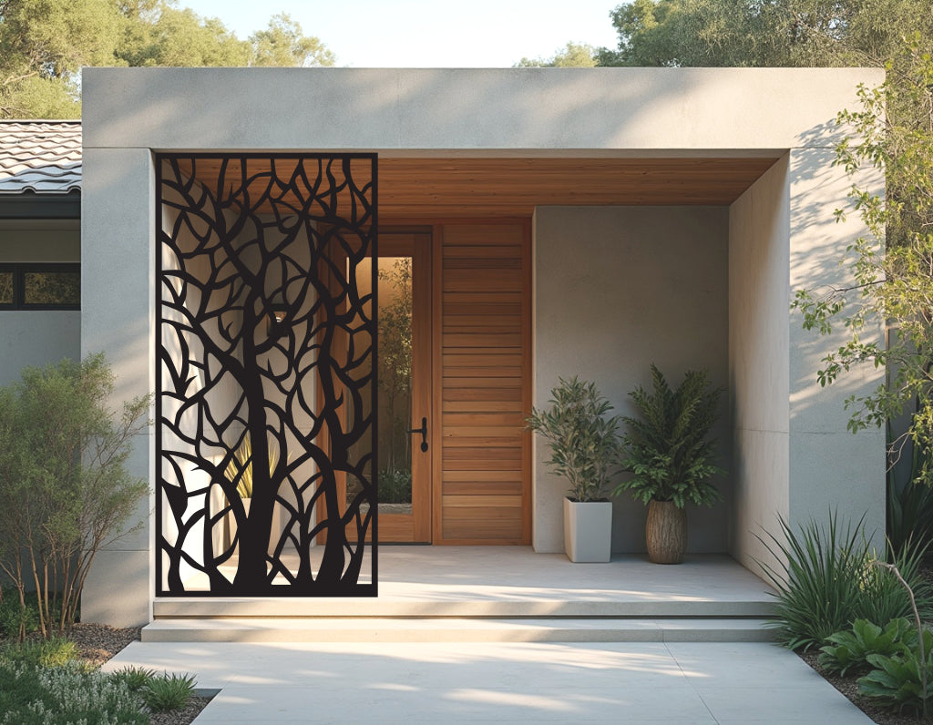 Metal privacy screen titled 'Wilderness Weave,' showcasing an intricate tree branch design, finished in Night Sky Matt Black powder coating. Positioned at the entrance of a modern home, it adds both privacy and artistic flair, seamlessly blending natural elements with contemporary architecture.